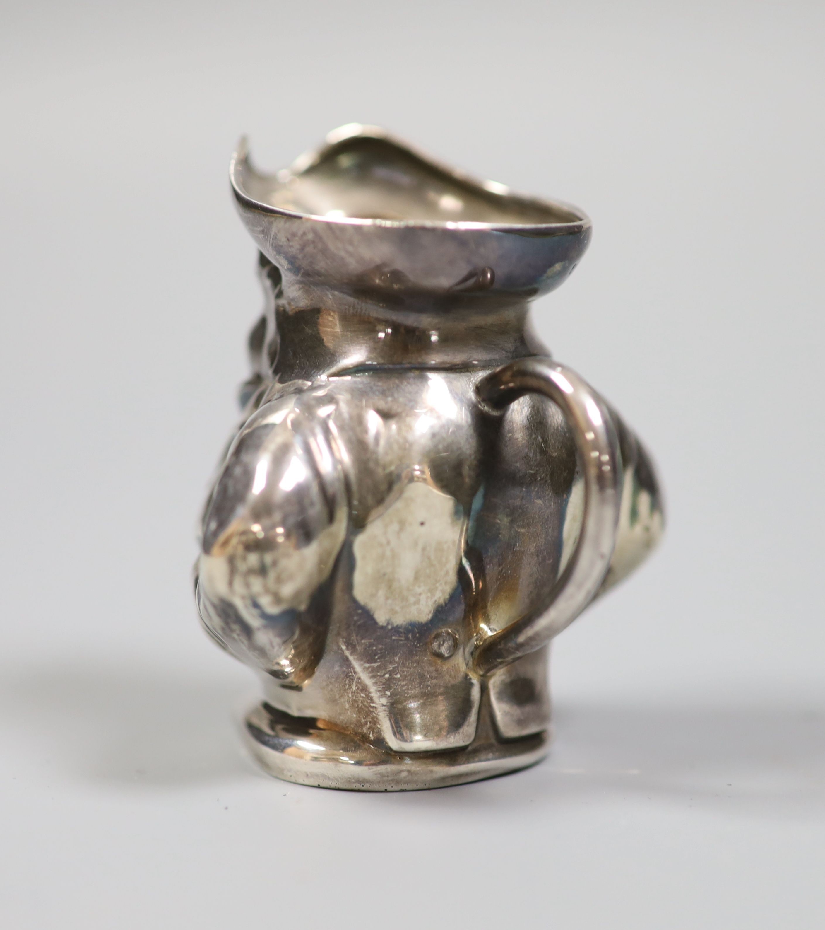 An Edwardian novelty silver cream jug modelled as a Toby jug, maker's mark rubbed, Birmingham, 1905, height 68mm.